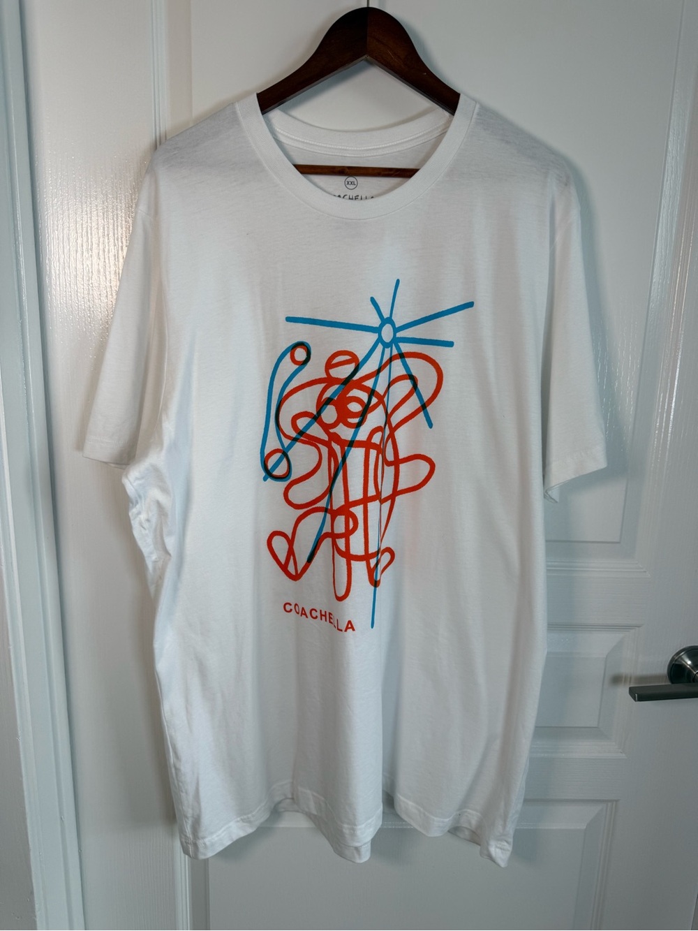 Coachella Women's White Short Sleeve Graphic Tee with Blue & Orange Design